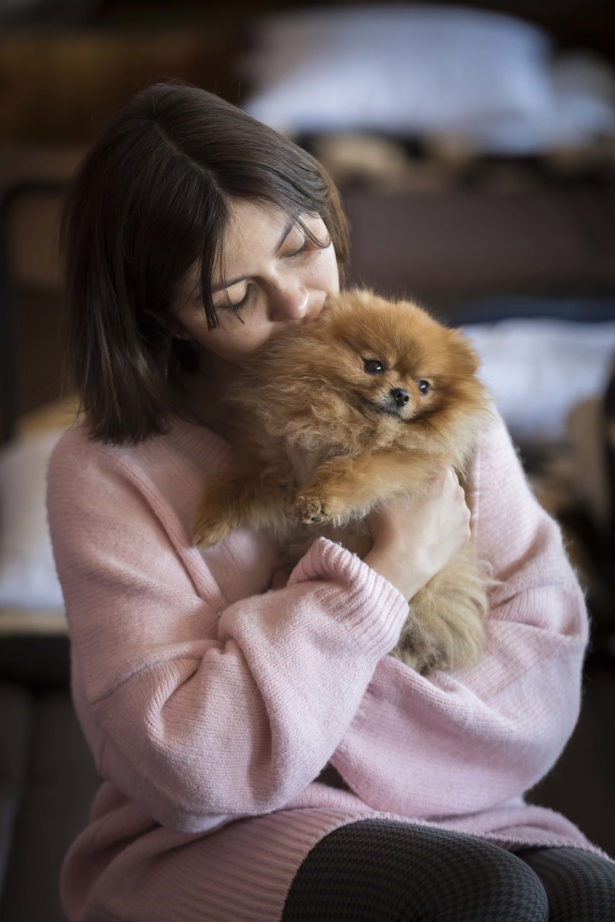 Ukrainian refugee Iuliia and her eight-year-old Pomeranian, Hugo Boss, photographed at the refugee center in Korczowa, Poland.